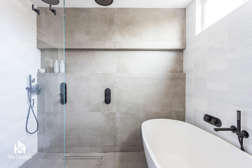 Walk-in shower with dark fixtures in the West Hills bathroom remodel