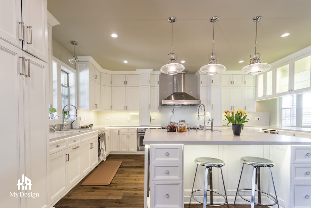 White kitchen with island and pendant lights in the second Irvine project