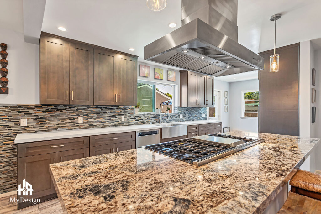 Granite counters and range hood in the Long Beach kitchen remodel