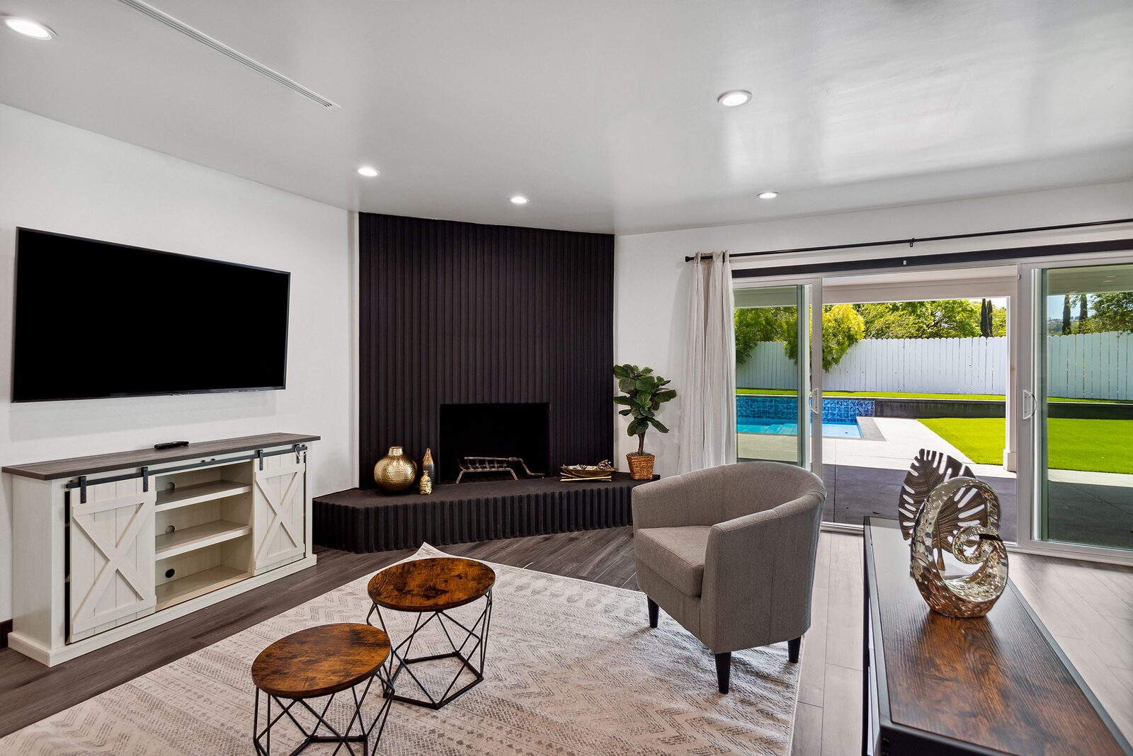Luxury home construction living room opening to the pool in West Hills