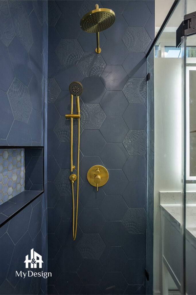 Navy hexagon-tiled shower with a gold rain head in the Sherman Oaks ADU