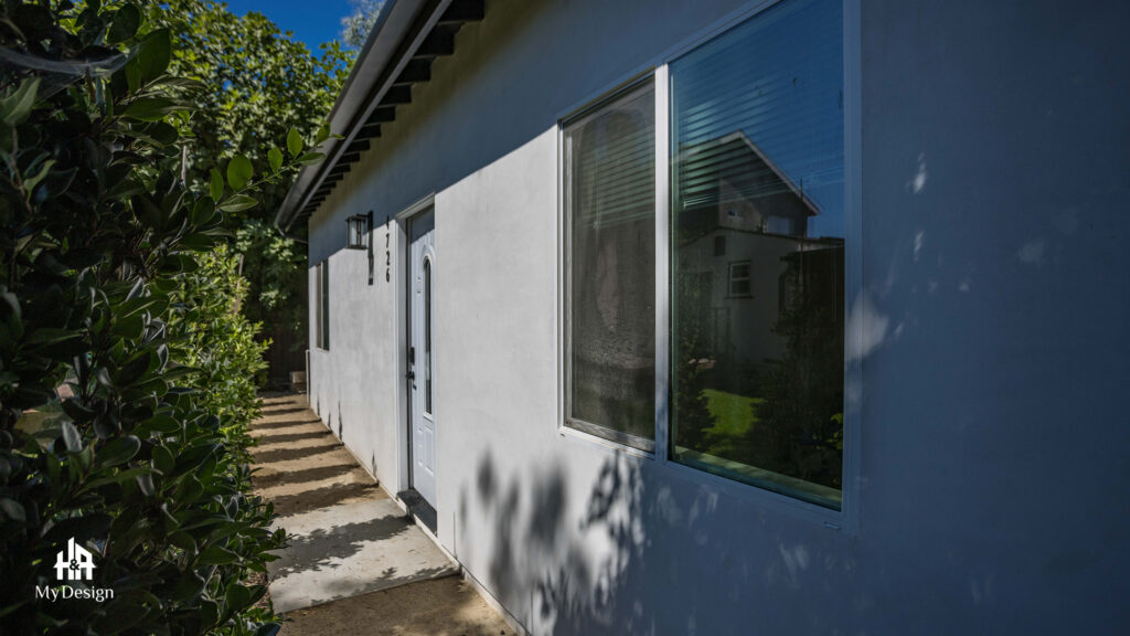 Side elevation of the detached ADU in Sherman Oaks with stucco walls and a navy accent wall