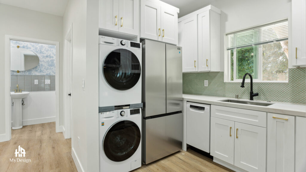 Compact ADU kitchen with stainless appliances and a view through to the bathroom