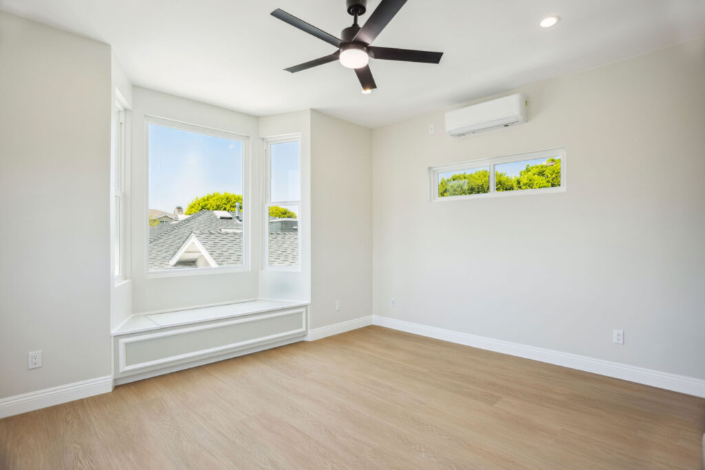 Upstairs room with a bay window, ceiling fan and mini-split in the Culver City ADU