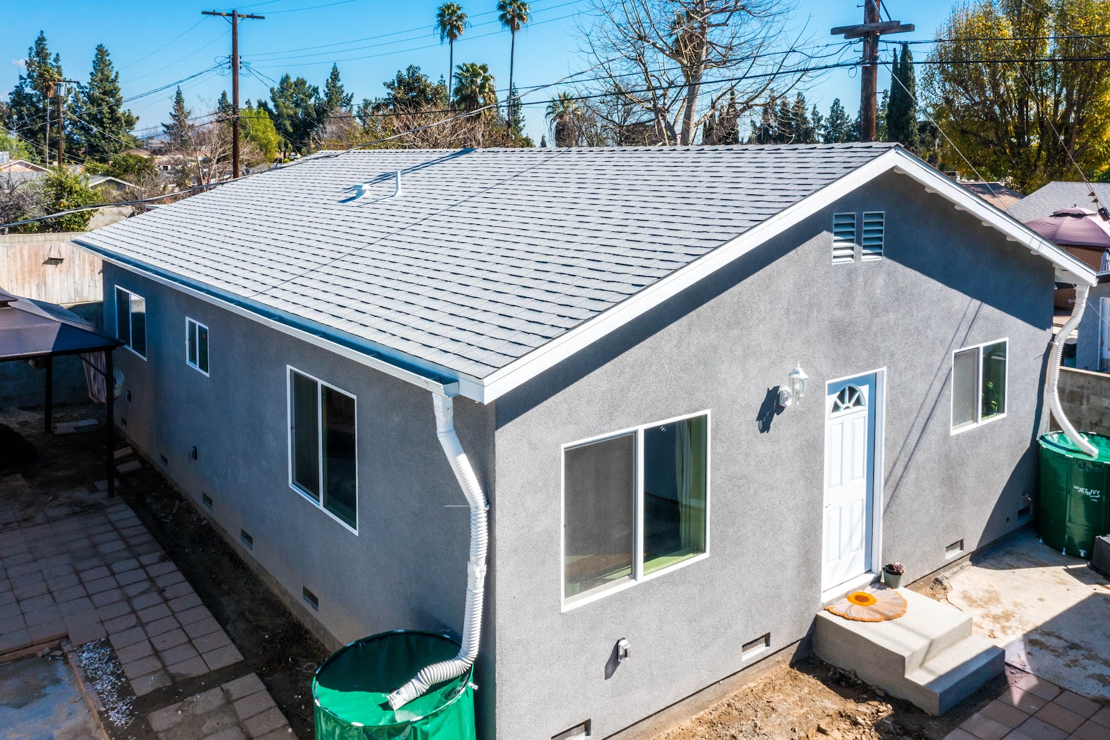 Aerial view of a detached ADU roof in the rear yard of a property