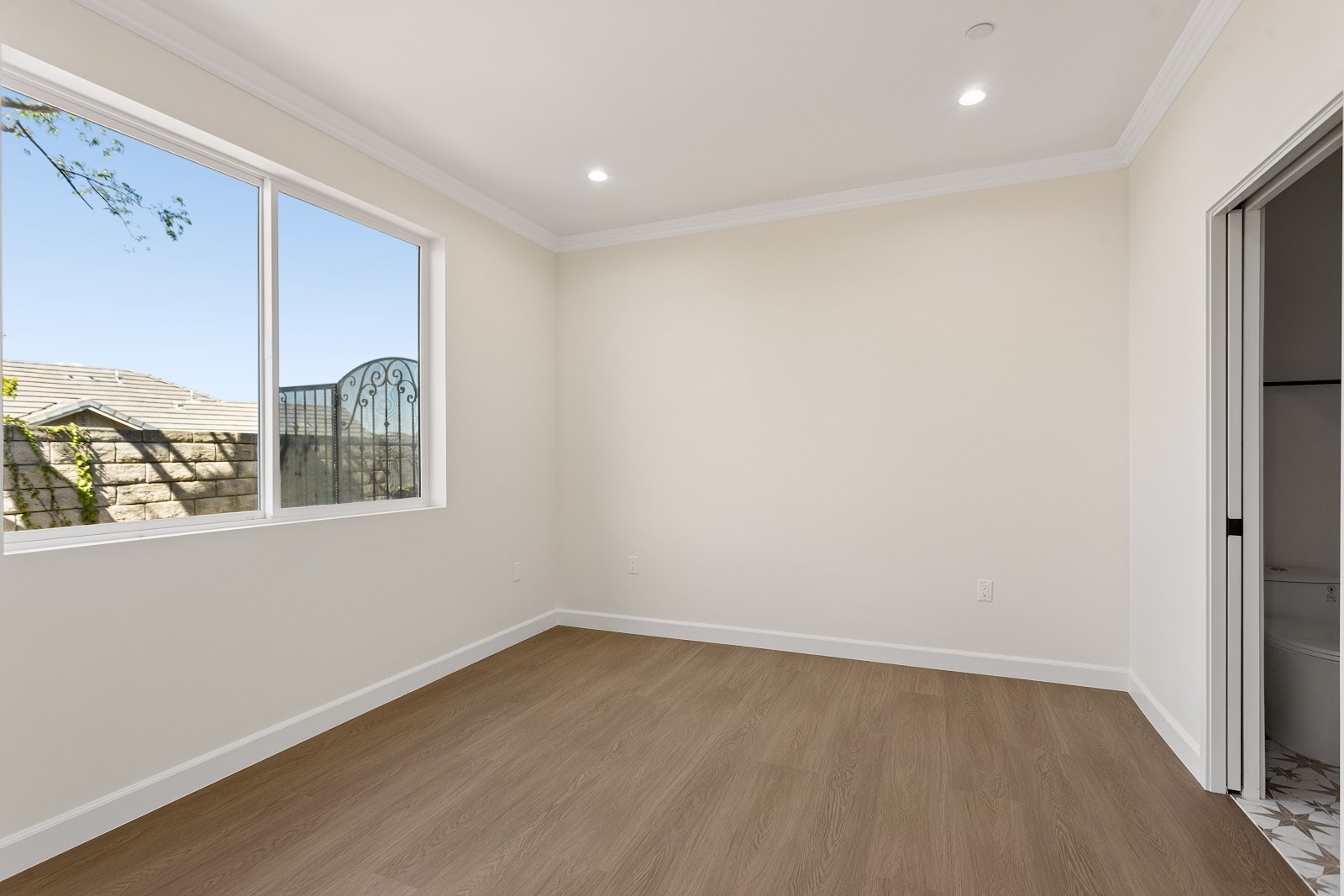 ADU bedroom with a large window framing a long view