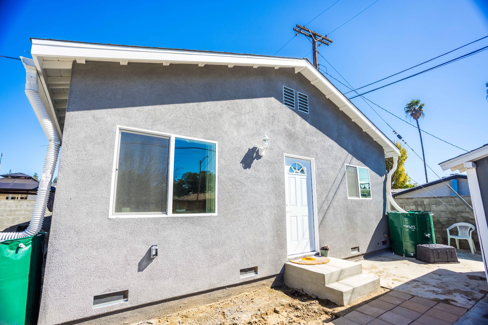 ADU under construction with fresh stucco and new windows installed