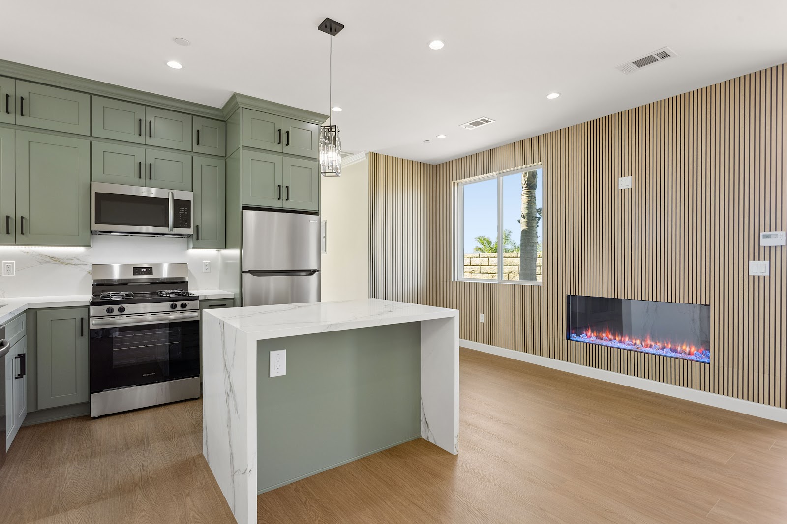 Open plan ADU kitchen with a sliding door onto a private patio
