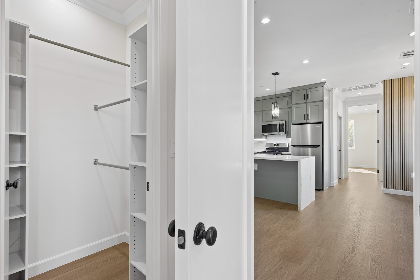 Walk in closet with hanging rails and shelving inside an ADU