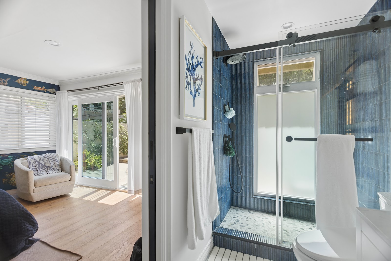 Bedroom with an ensuite shower finished in blue vertical tile