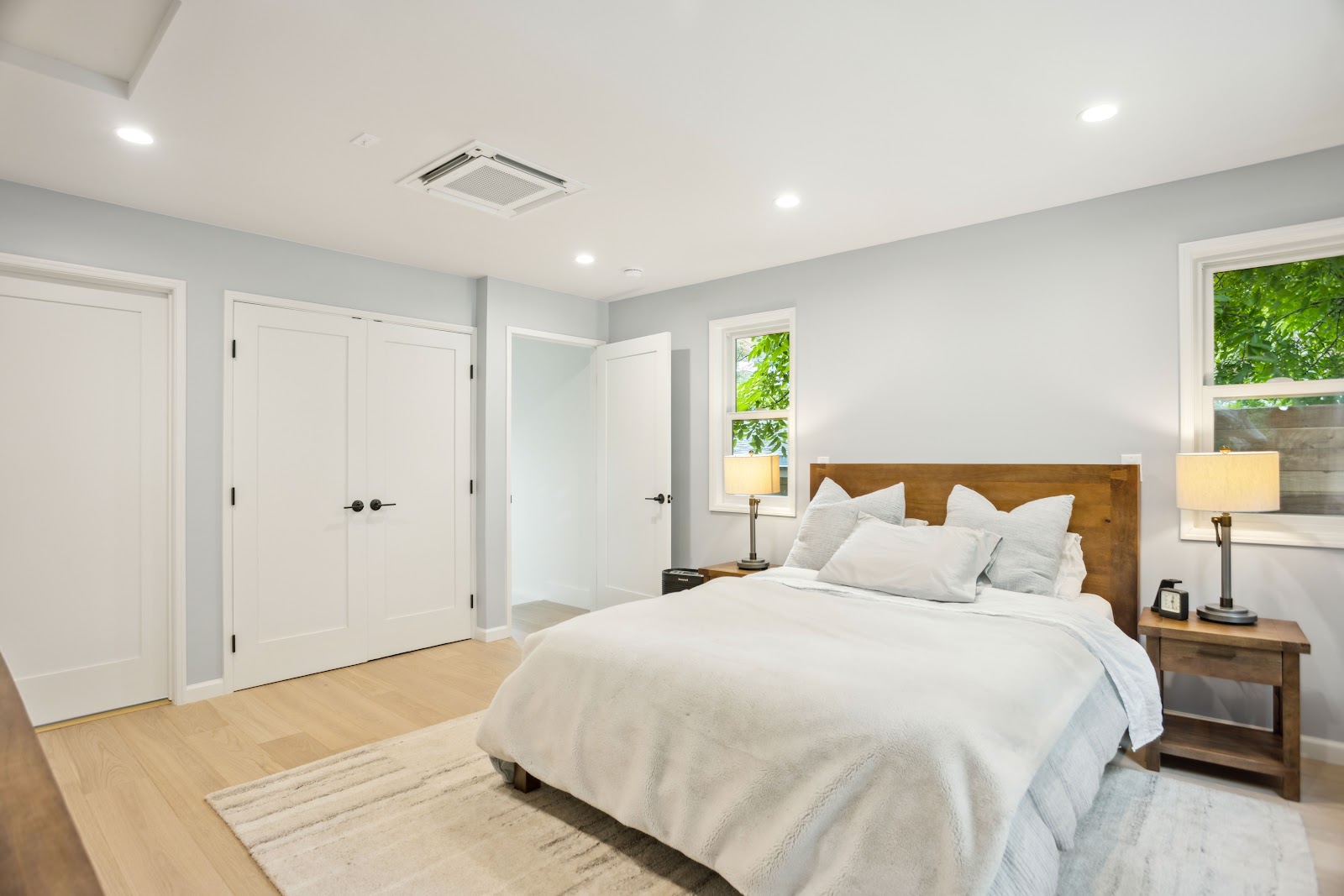 Bedroom remodel with built in closet doors and bedside lighting