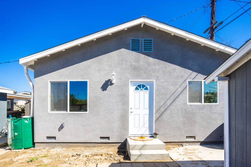 Building an ADU: finished exterior with new composition roof and stucco