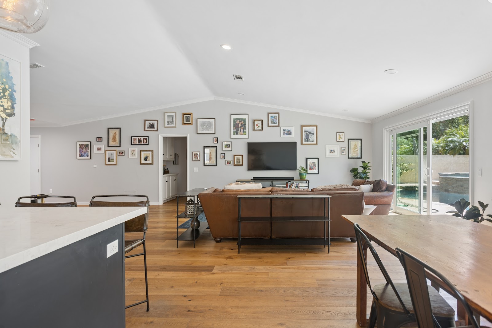 Great room with a vaulted ceiling and a framed gallery wall
