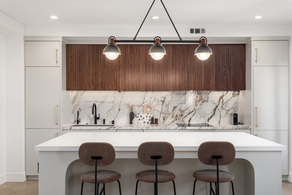 Home remodeling ideas: walnut fluted cabinets and a marble slab backsplash