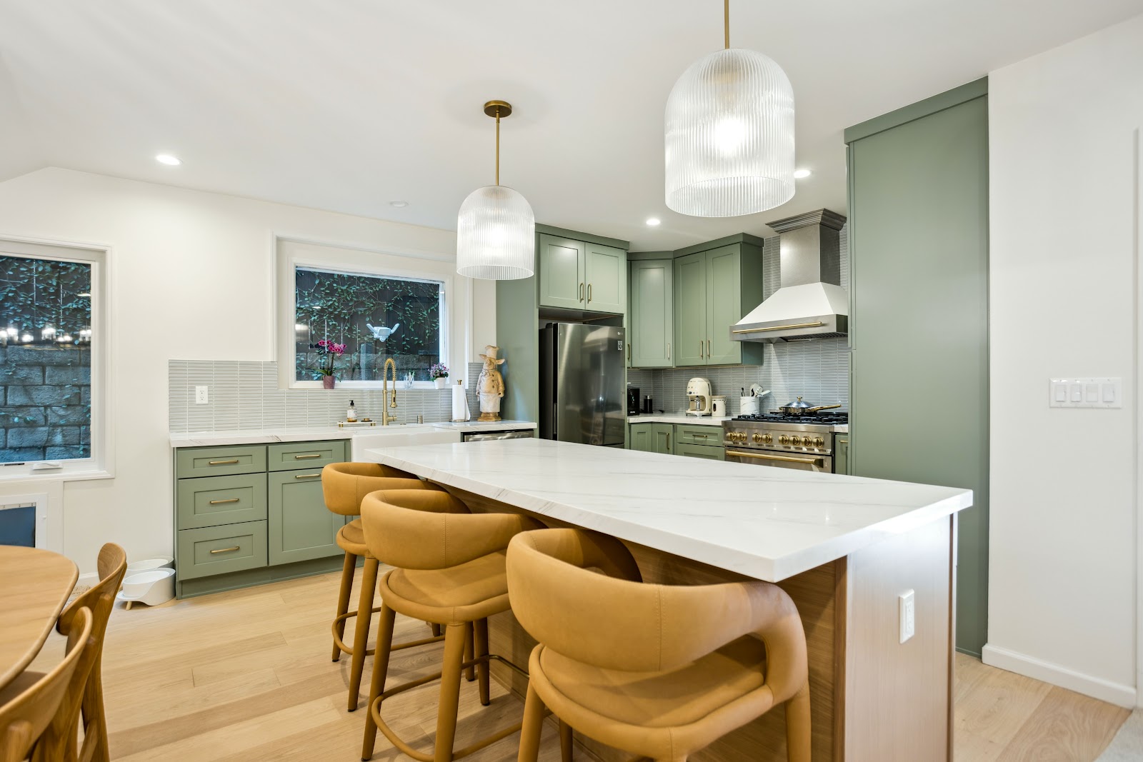 Kitchen island with waterfall quartz and leather bar stools