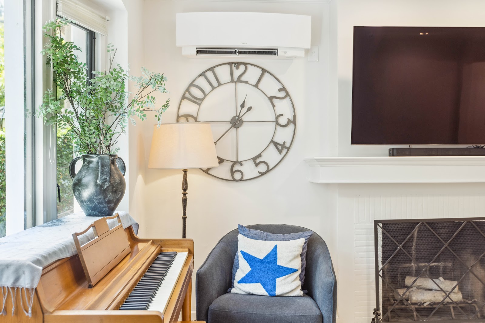 Living room fireplace with a wall mounted mini split above the seating