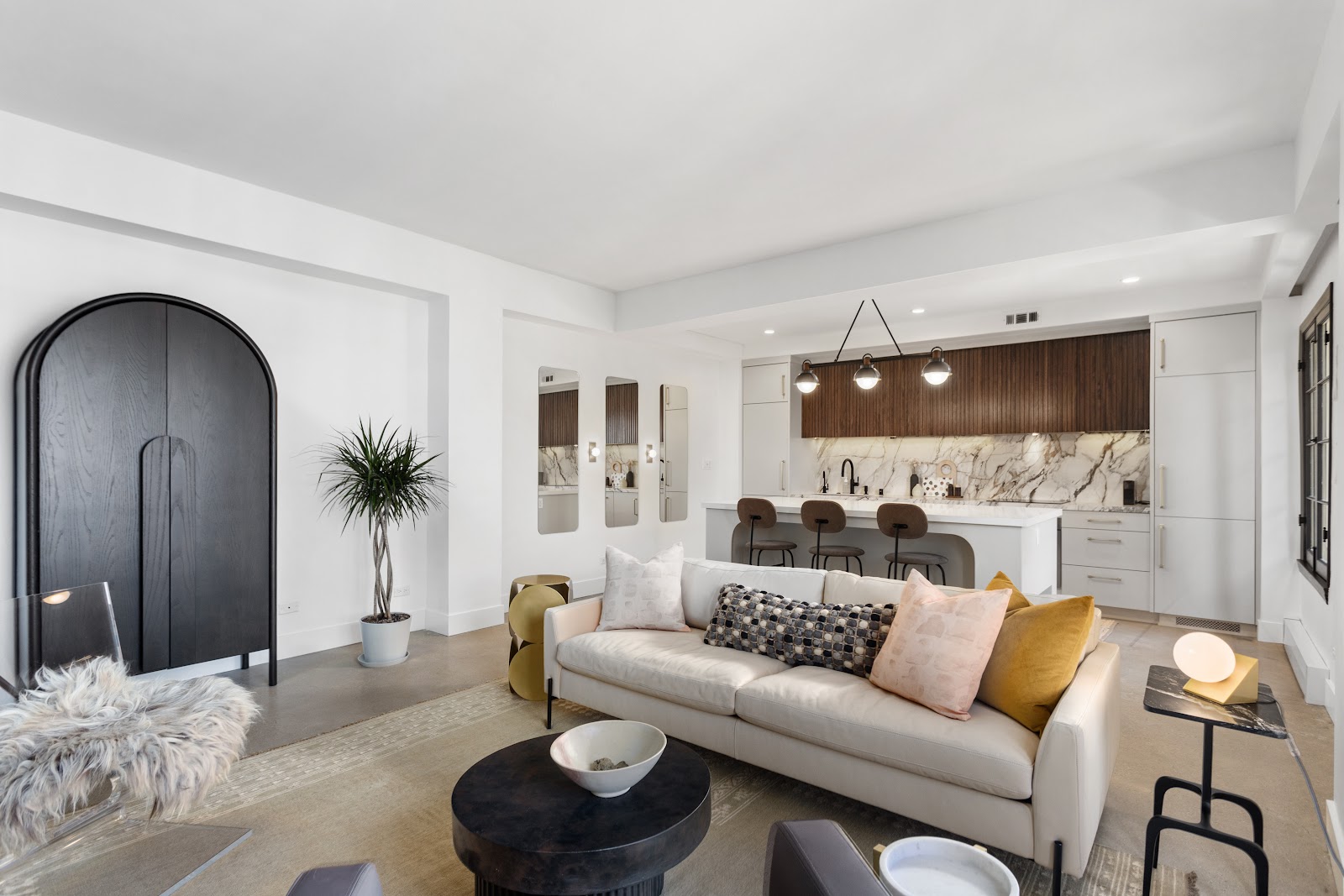 Living room remodel with a black arched front door and built-in shelving