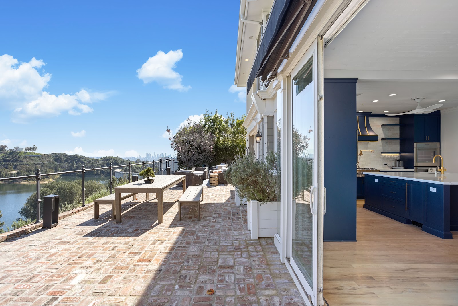 Paver terrace with an outdoor dining table opening off the kitchen