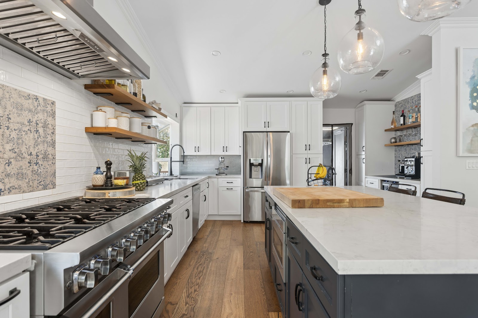 White shaker kitchen with a butcher block set into the island end